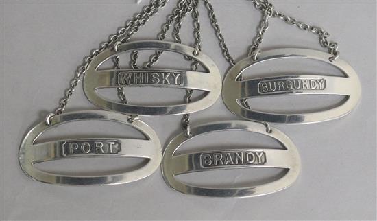 A matched set of early 20th century silver wine/spirit labels by Sampson Mordan & Co, Chester, 1908/11 & London, 1925, 58mm.